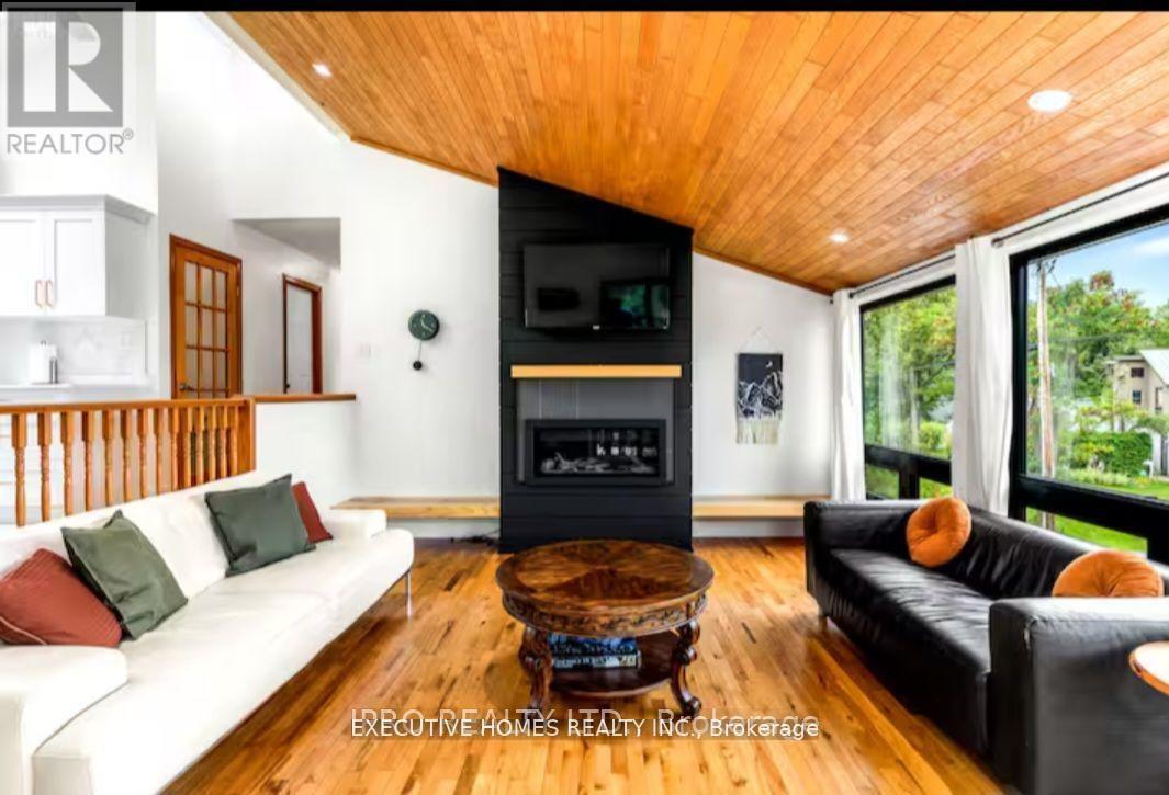 39 Long Point Road, Tay, ON - Indoor Photo Showing Living Room With Fireplace
