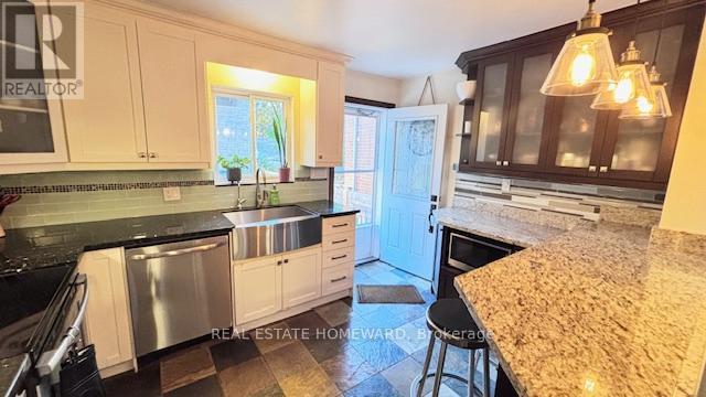 Kitchen with Rear Door - Main & 2Nd Floors - 457 Mortimer Avenue, Toronto, ON - Indoor Photo Showing Other Room With Fireplace