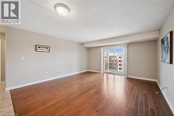 Spare room featuring wood finished floors and a textured ceiling -