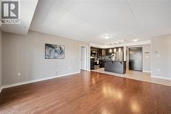 Unfurnished living room with a textured ceiling and light wood-style flooring -
