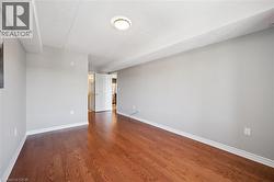 Unfurnished room with a textured ceiling and dark wood-style floors -