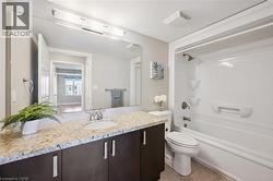 Bathroom featuring vanity, shower combination, and tile patterned flooring -