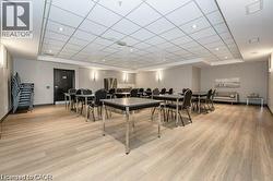 Dining room featuring light wood finished floors, a drop ceiling, and recessed lighting -