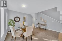 Dining room with light wood-type flooring and baseboards -