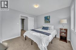 Bedroom with light carpet and baseboards -