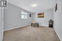 Unfurnished room featuring light carpet and baseboards -