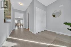 Hall featuring baseboards and light tile patterned floors -