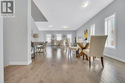 Dining space featuring light wood-style flooring and baseboards -