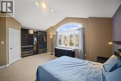 Bedroom featuring lofted ceiling, carpet, and a closet -