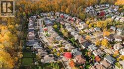 Aerial view of property and surrounding area with nearby suburban area -