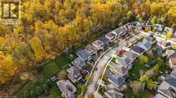 Aerial view of property and surrounding area with nearby suburban area -