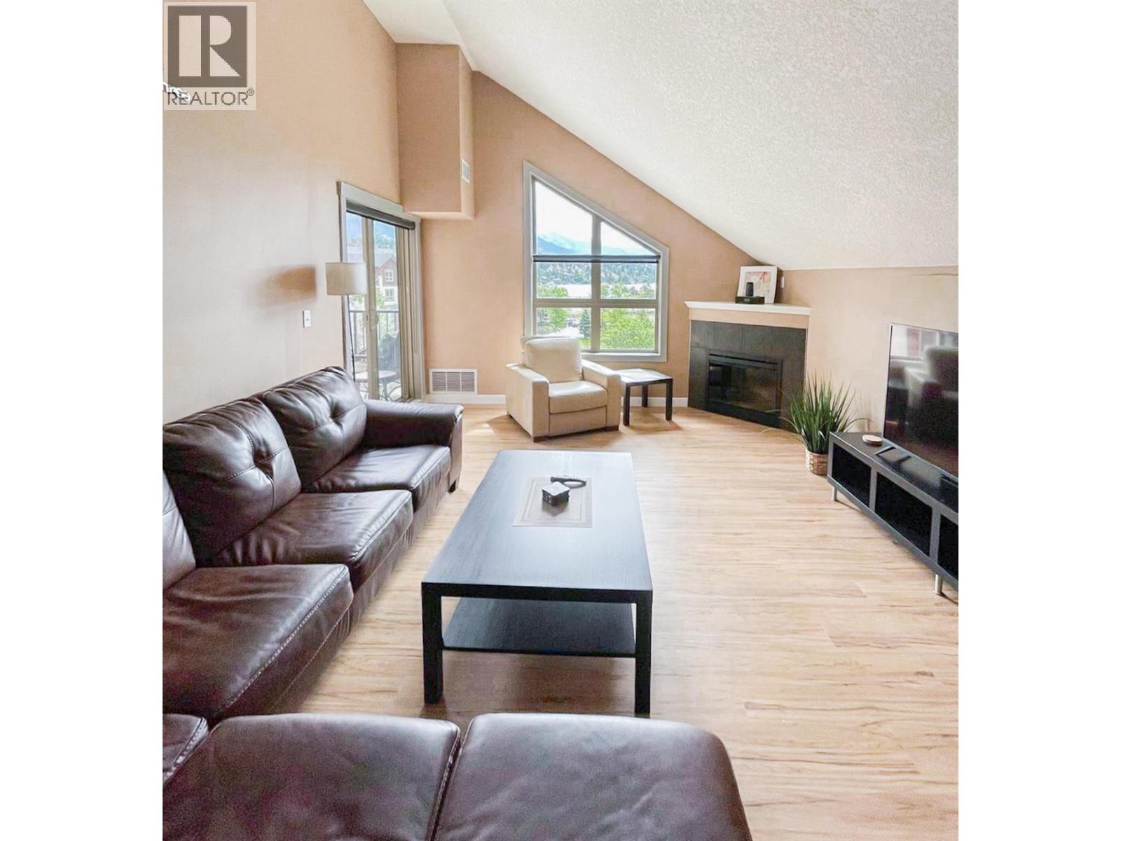 205 Third Avenue Unit# 3420, Invermere, BC - Indoor Photo Showing Living Room With Fireplace
