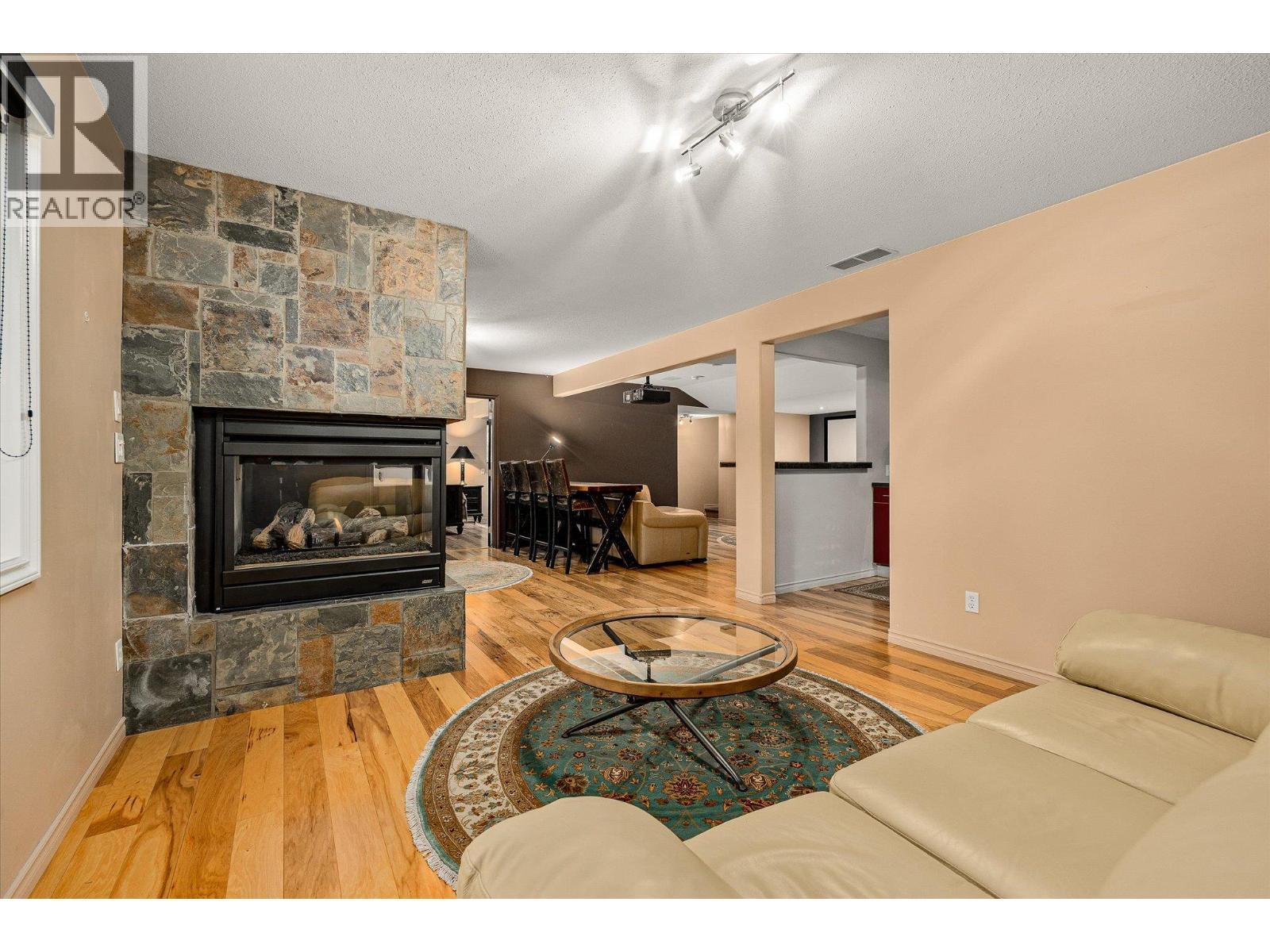 3929 Gallaghers Circle, Kelowna, BC - Indoor Photo Showing Living Room With Fireplace