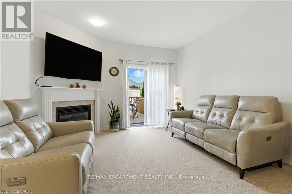 20 - 310 Southbrook Drive, Hamilton, ON - Indoor Photo Showing Living Room With Fireplace