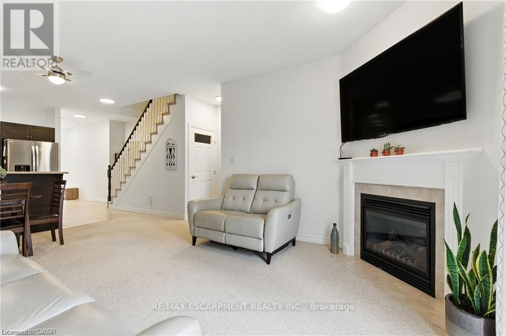 20 - 310 Southbrook Drive, Hamilton, ON - Indoor Photo Showing Living Room With Fireplace