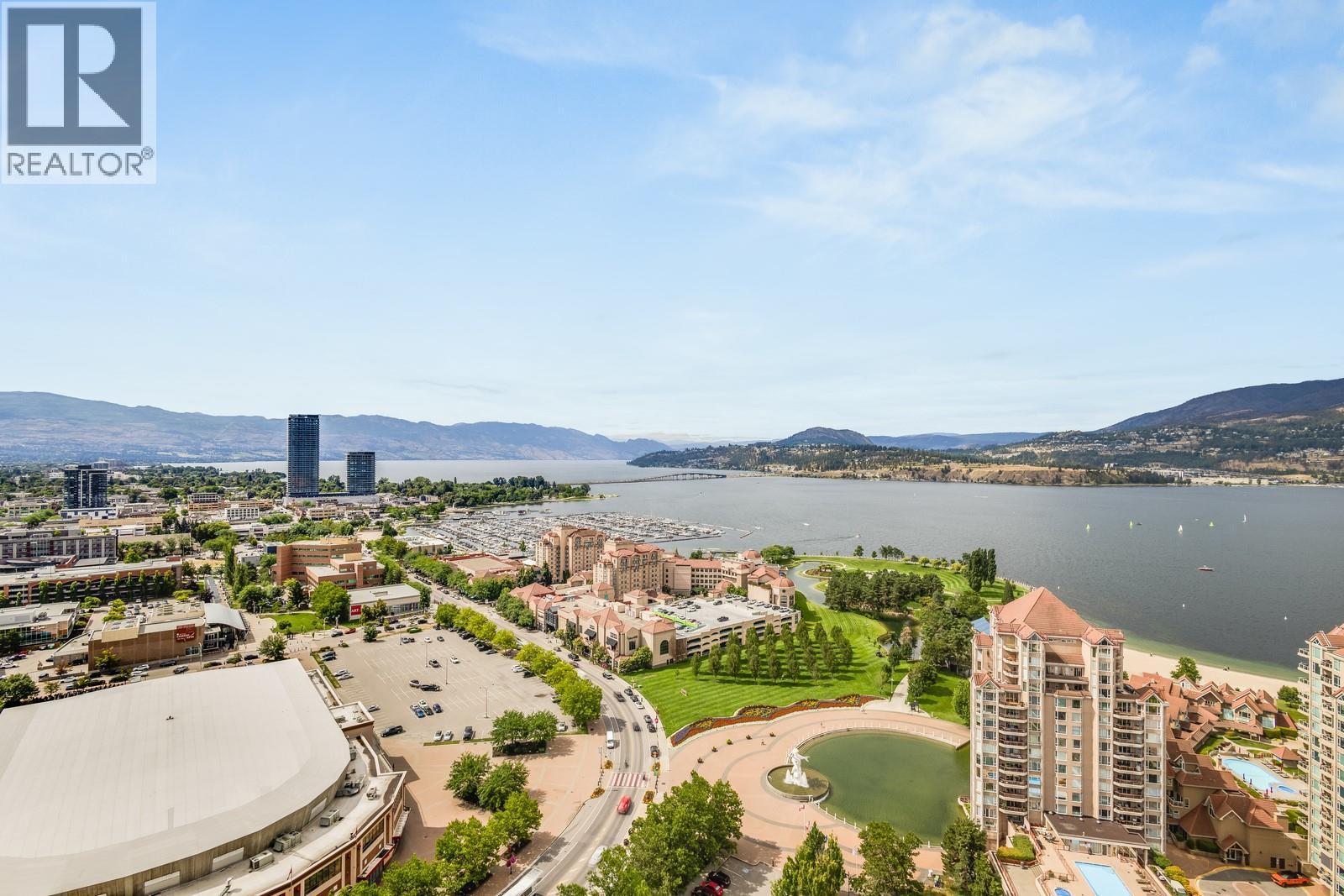 ...and taking in this incredible view! - 1181 Sunset Drive Unit# 2602, Kelowna, BC - Outdoor With Body Of Water With View