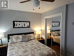 Primary bedroom with mirrored closet doors. -