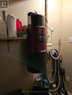 Central vacuum with accessories in utility room. -