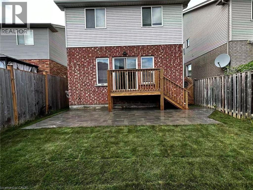 Rear view of property with brick siding, a fenced backyard, a patio area, and a deck - 590 Little Dover Crescent, Waterloo, ON - Outdoor With Deck Patio Veranda With Exterior
