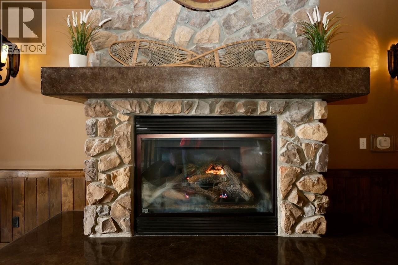 1549 Kicking Horse Trail Unit# 415 (A&B), Golden, BC - Indoor Photo Showing Living Room With Fireplace