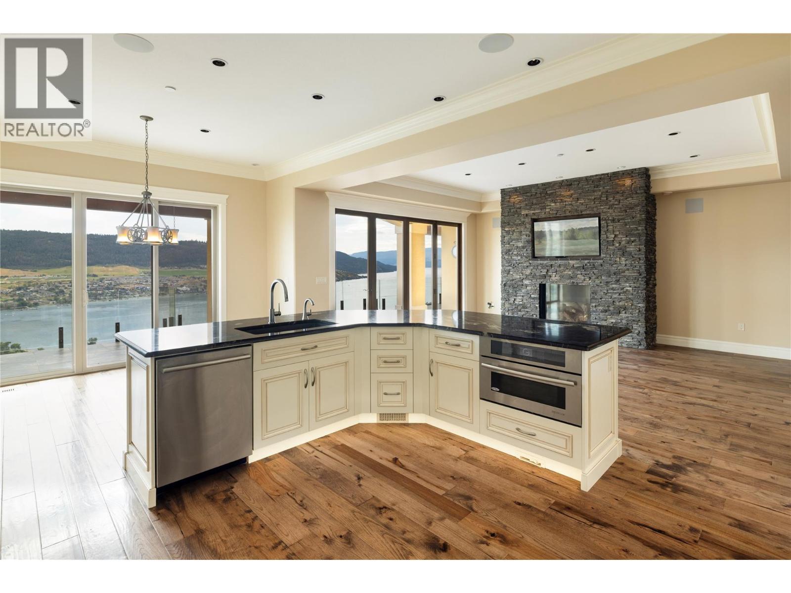 Over-sized Kitchen Island Featuring Stone Countertops and Under Cabinet Lighting - 108 Vineyard Way, Vernon, BC - Indoor Photo Showing Kitchen With Upgraded Kitchen