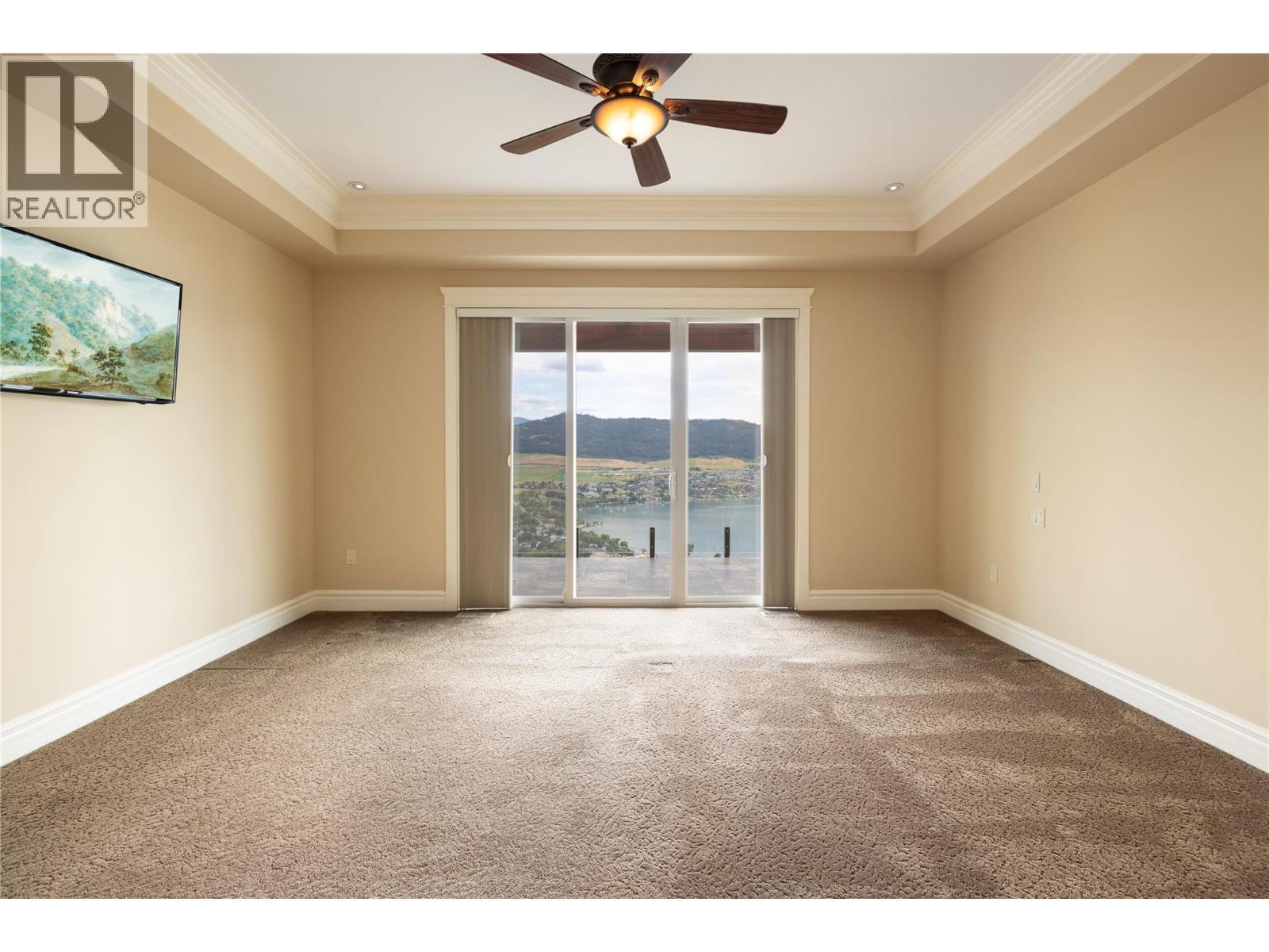 Primary Suite Featuring Unobstructed Lake & Mountain Views - 108 Vineyard Way, Vernon, BC - Indoor Photo Showing Other Room