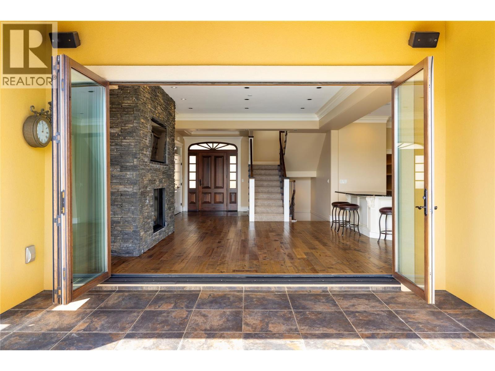 Looking back into main floor - 108 Vineyard Way, Vernon, BC - Indoor Photo Showing Other Room With Fireplace