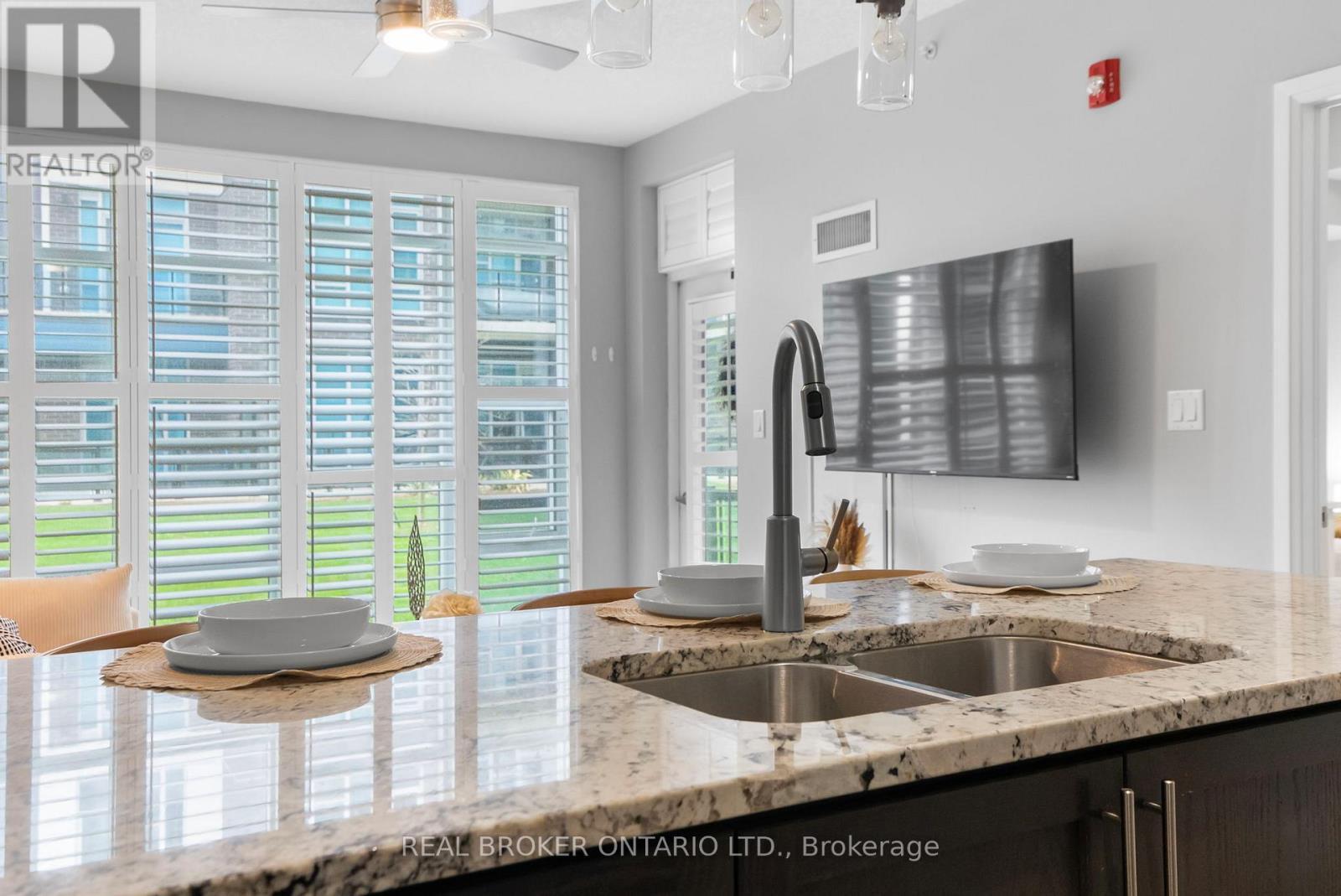 110 - 10 Concord Place W, Grimsby, ON - Indoor Photo Showing Kitchen With Double Sink