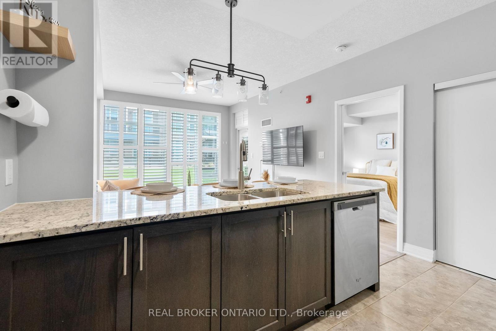 110 - 10 Concord Place W, Grimsby, ON - Indoor Photo Showing Kitchen With Double Sink