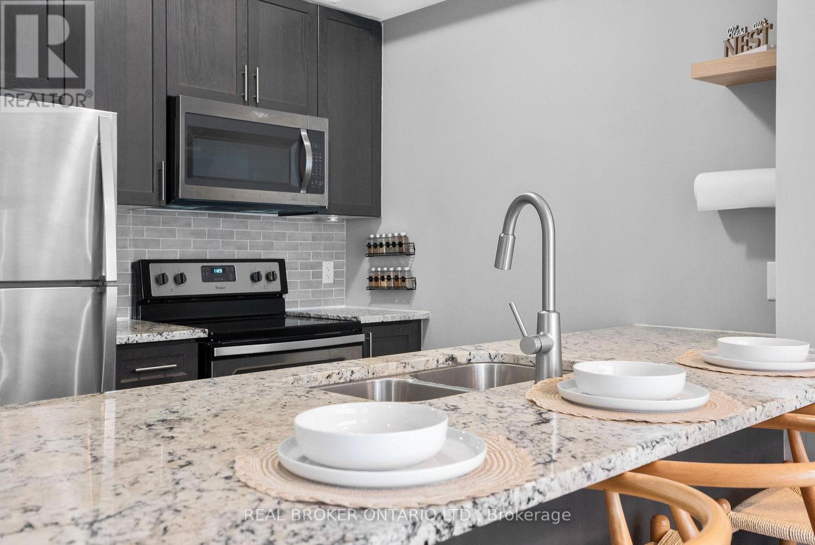 110 - 10 Concord Place W, Grimsby, ON - Indoor Photo Showing Kitchen With Stainless Steel Kitchen With Double Sink With Upgraded Kitchen