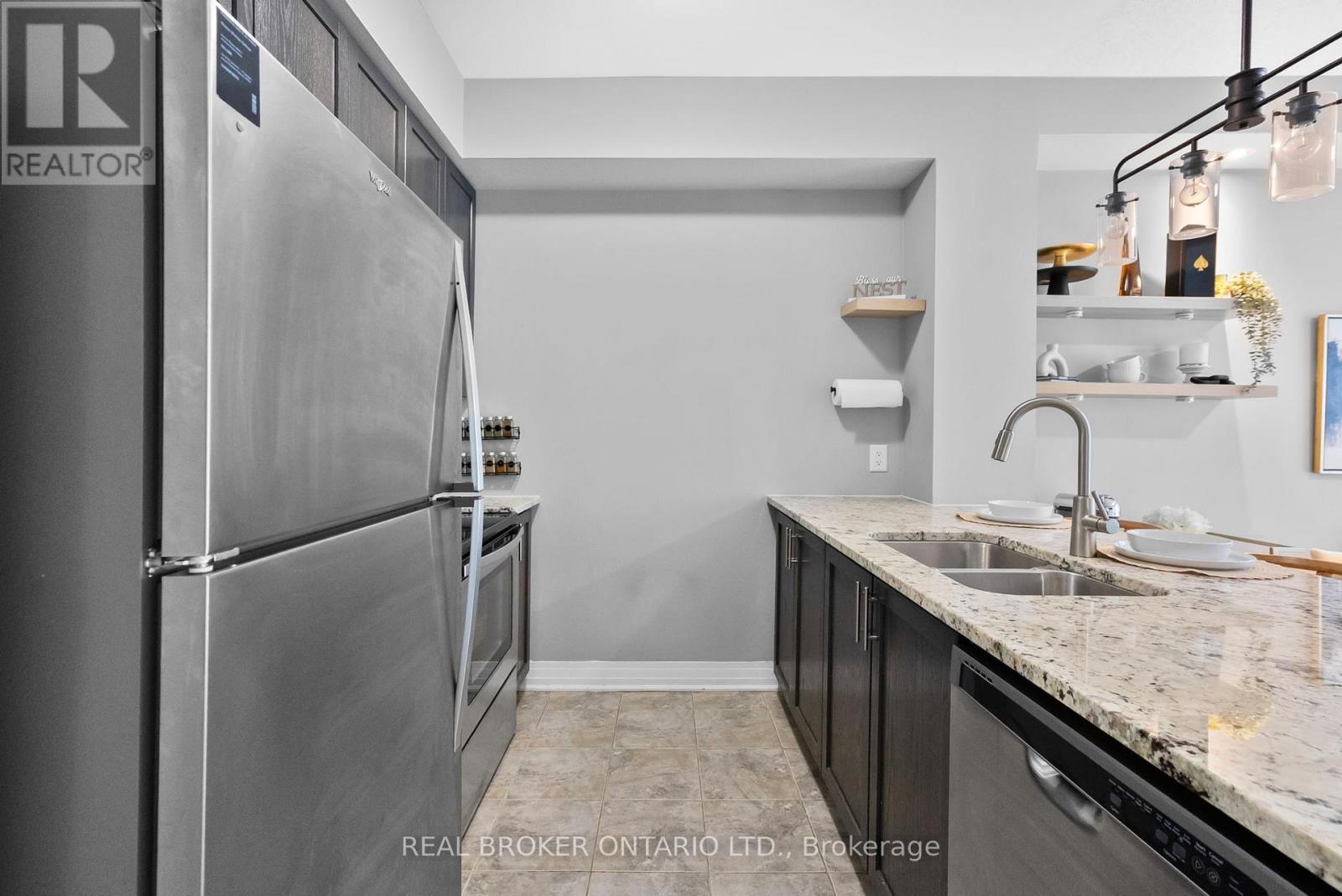 110 - 10 Concord Place W, Grimsby, ON - Indoor Photo Showing Kitchen With Stainless Steel Kitchen With Double Sink
