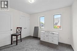 Unfurnished bedroom featuring carpet floors, baseboards, and a closet -
