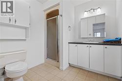Full bath with baseboards, toilet, a shower stall, and vanity -