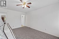 Unfurnished room with carpet flooring, ceiling fan, and baseboards -