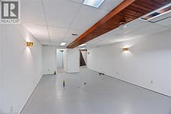 Finished below grade area featuring stairs and a drop ceiling -