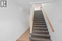 Stairs featuring tile patterned floors -