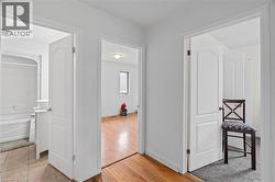 Corridor with light wood-style floors and baseboards -