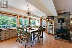 Dining room wall of windows & woodstove -