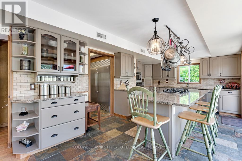 Kitchen island breakfast-bar and endless cabinetry - 320 Pike Lake Route 12 Road, Tay Valley, ON - Indoor Photo Showing Dining Room