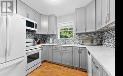 Apartment kitchen has quartz countertops -