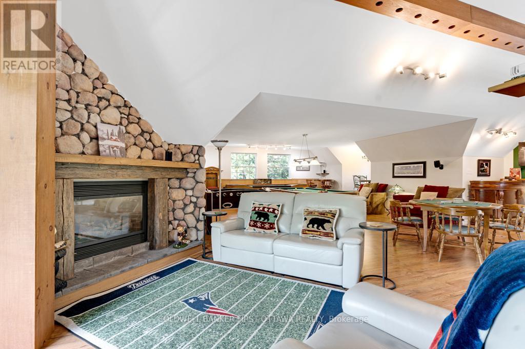 Loft open floor plan & defined spaces - 320 Pike Lake Route 12 Road, Tay Valley, ON - Indoor With Fireplace