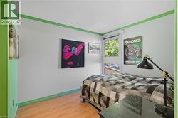 Bedroom featuring light wood finished floors and a textured ceiling -
