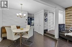 Dining area featuring dark wood finished floors, a chandelier, and a textured ceiling -