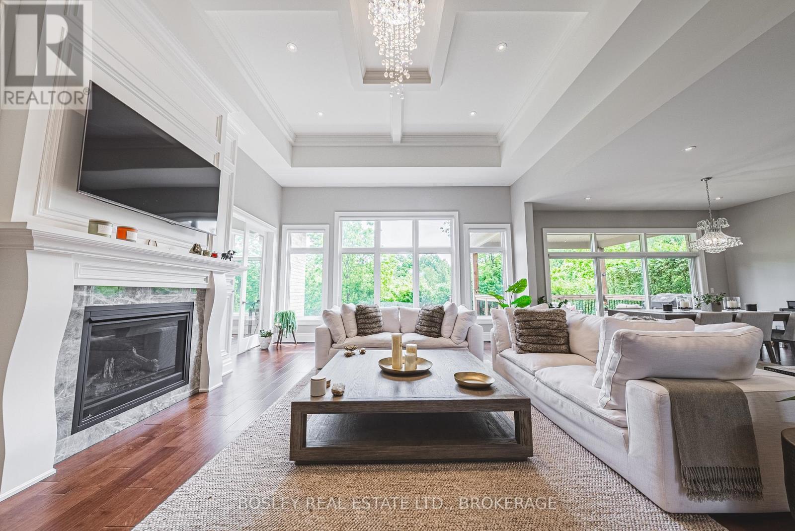 TONS of natural light highlighting the backyard - 32 Philmori Boulevard, Pelham (Fonthill), ON - Indoor Photo Showing Living Room With Fireplace