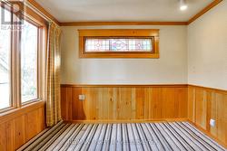 Family room; wainscotting & stained glass window. -