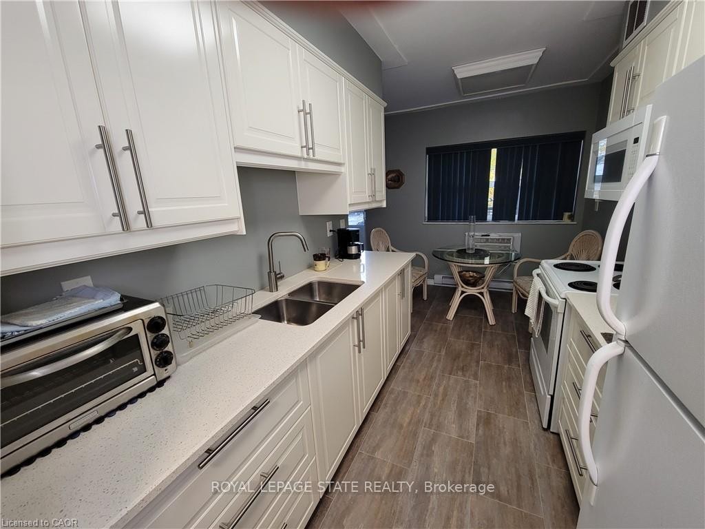 210-11 Woodman Drive S, Hamilton, ON - Indoor Photo Showing Kitchen With Double Sink