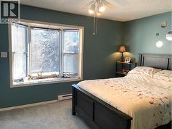 Primary bedroom with bay window overlooking the backyard -