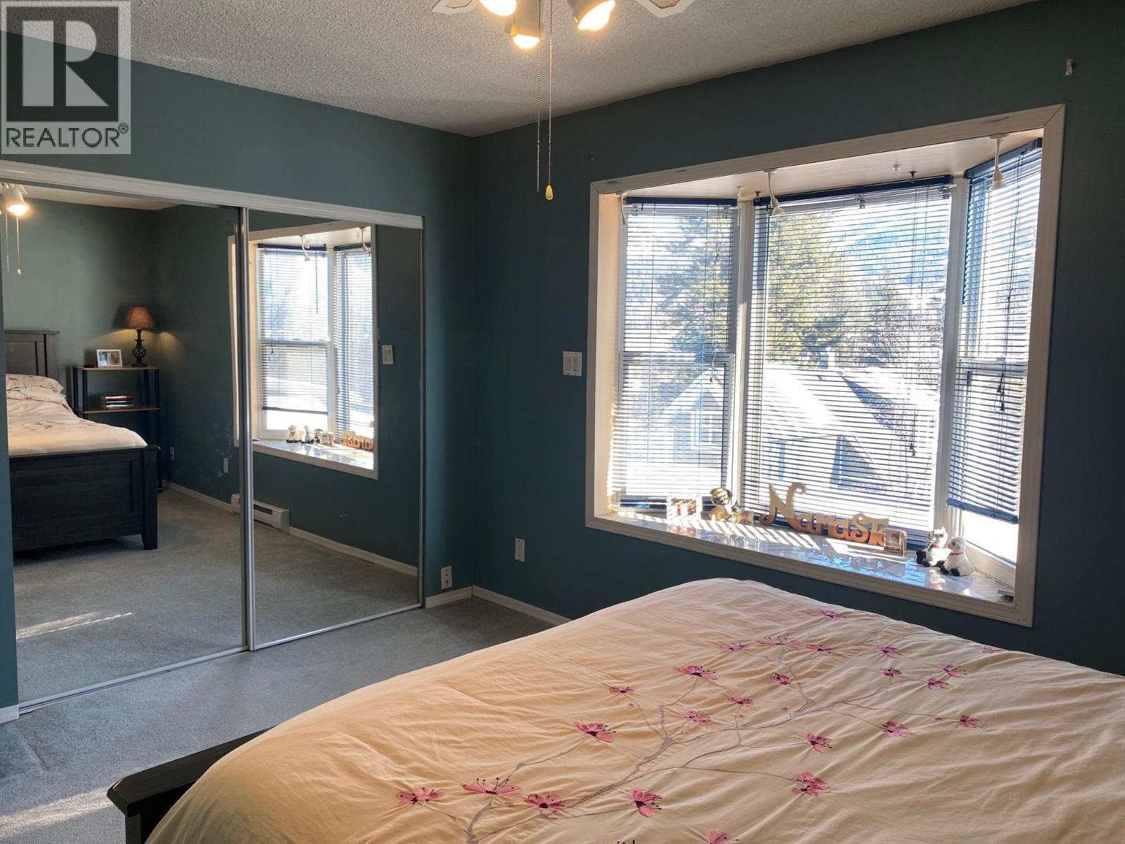 Large closets in Primary bedroom - 1768 First Street, Fruitvale, BC - Indoor Photo Showing Bedroom