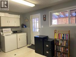 Laundry Room on lower level with next to outside entrance -