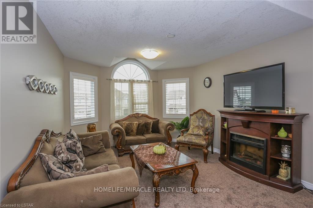 2879 Lemieux Walk, London South, ON - Indoor Photo Showing Living Room With Fireplace